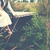 Bride and groom looking out onto a pond after discussing wedding wellbeing