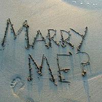Marry me written in the sand at the beach Marry me written in the sand at the beach