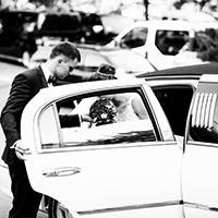 man helping bride out of limosine man helping bride out of limosine