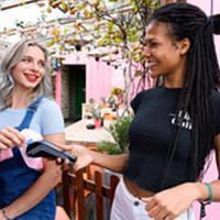 Girl using Pingit sash to pay bill on Hen do Girl using Pingit sash to pay bill on Hen do