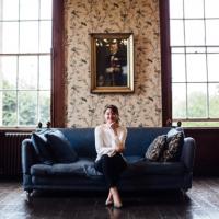 Wedding planner sat on navy couch Wedding planner sat on navy couch