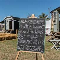 Couple outside shephard huts Couple outside shephard huts